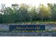 Elegant sign for Anthem Country Club on stone wall with flowering plants at the base at 1 Ibis Ct, Henderson, NV 89052