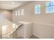 Bright staircase landing with natural light from multiple windows at 1 Ibis Ct, Henderson, NV 89052