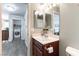 Half bathroom boasts a single sink, vanity and toilet; the laundry is conveniently located nearby at 10745 Leatherstocking Ave, Las Vegas, NV 89166