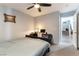 Inviting bedroom featuring neutral walls, a ceiling fan, a desk, and easy access to stairs at 10745 Leatherstocking Ave, Las Vegas, NV 89166