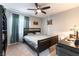 Inviting bedroom featuring neutral walls, a ceiling fan, a desk, and warm natural light at 10745 Leatherstocking Ave, Las Vegas, NV 89166