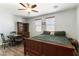 Comfortable bedroom featuring a ceiling fan, a large bed with a classic wooden frame, and ample natural light at 10745 Leatherstocking Ave, Las Vegas, NV 89166