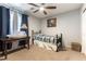 Relaxing bedroom with a ceiling fan, a comfortable bed with a patterned comforter, and neutral carpeting at 10745 Leatherstocking Ave, Las Vegas, NV 89166