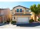 Two-story tan home features a two-car garage, charming architectural details, and well-maintained landscaping at 10745 Leatherstocking Ave, Las Vegas, NV 89166