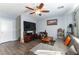 Cozy living area showcasing a large TV, ceiling fan, and modern flooring at 10745 Leatherstocking Ave, Las Vegas, NV 89166