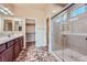 Bathroom featuring double sink vanity and separate glass-enclosed shower at 10746 Lightning Sky St, Las Vegas, NV 89179