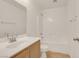 This bathroom features a single sink vanity, a mirror, and a shower-tub combo with white tile surround at 11103 African Sunset St, Henderson, NV 89052