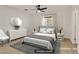 Staged bedroom with neutral decor, large window, and gray accents at 11103 African Sunset St, Henderson, NV 89052