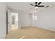 Bright bedroom with plush carpeting, ceiling fan, and natural light at 11103 African Sunset St, Henderson, NV 89052