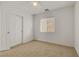 A bedroom with neutral carpet, white walls, and a window at 11103 African Sunset St, Henderson, NV 89052