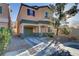 Two-story home showcasing charming curb appeal, a well-manicured front yard, and an attached one car garage at 11103 African Sunset St, Henderson, NV 89052