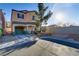 Lovely two-story home with a one-car garage, desert landscaping and a paved driveway at 11103 African Sunset St, Henderson, NV 89052