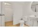 A clean half-bathroom features a pedestal sink, toilet, and tiled flooring at 11103 African Sunset St, Henderson, NV 89052