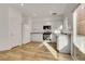 Bright kitchen featuring white cabinetry, stainless steel appliances, and light wood flooring at 11103 African Sunset St, Henderson, NV 89052