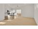 Bright, open-concept living room and kitchen with modern appliances and sliding glass door to outdoor area at 11103 African Sunset St, Henderson, NV 89052
