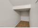 Compact walk-in closet featuring neutral walls and tiled flooring with a shelf above at 11103 African Sunset St, Henderson, NV 89052