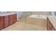 Luxurious bathroom featuring tiled shower, a soaking tub, and double vanities for added convenience at 11354 Merado Peak Dr, Las Vegas, NV 89135