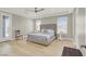 Neutral Primary bedroom featuring a tray ceiling, ceiling fan, and shuttered windows allowing ample sunlight at 11354 Merado Peak Dr, Las Vegas, NV 89135