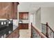 Upstairs hallway featuring beautiful wood cabinets, countertops, and stairway with elegant iron railing at 11354 Merado Peak Dr, Las Vegas, NV 89135