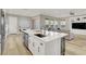 Spacious kitchen with a large island, white cabinets, and modern appliances, open to living area at 11354 Merado Peak Dr, Las Vegas, NV 89135