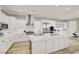 A bright kitchen features white cabinets, stainless steel appliances, and a spacious central island at 11354 Merado Peak Dr, Las Vegas, NV 89135