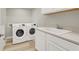 Well-equipped laundry room with modern appliances, a utility sink, and ample storage space at 11354 Merado Peak Dr, Las Vegas, NV 89135