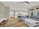 View of the living room, open to the kitchen, with modern furniture and neutral decor at 11354 Merado Peak Dr, Las Vegas, NV 89135