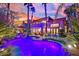 Spectacular home exterior with a private pool, patio area, and manicured landscaping at sunset at 116 N Ring Dove Dr, Las Vegas, NV 89144