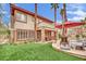 Beautiful backyard with outdoor seating, stone features, and lush landscaping at 116 N Ring Dove Dr, Las Vegas, NV 89144