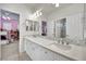 Bright bathroom featuring double sinks, a marble countertop, and shower stall at 116 N Ring Dove Dr, Las Vegas, NV 89144