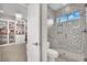 Bright bathroom with marble shower, tile flooring and a view into a bedroom at 116 N Ring Dove Dr, Las Vegas, NV 89144