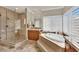 Elegant bathroom features a glass-enclosed shower, large soaking tub, and dual sinks at 116 N Ring Dove Dr, Las Vegas, NV 89144