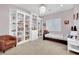 Bright bedroom with custom built-in bookshelves, a decorative chandelier and a cozy chair at 116 N Ring Dove Dr, Las Vegas, NV 89144