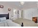 Bright bedroom features a decorative chandelier, closet space and an en suite bathroom at 116 N Ring Dove Dr, Las Vegas, NV 89144