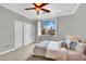 Neutral toned bedroom with large window, closet and stylish decor at 116 N Ring Dove Dr, Las Vegas, NV 89144