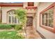 Charming home entrance with a stone pathway, lush landscaping, and decorative front door at 116 N Ring Dove Dr, Las Vegas, NV 89144