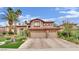 Attractive two-story home with a three-car garage, stone accents, and manicured landscaping at 116 N Ring Dove Dr, Las Vegas, NV 89144