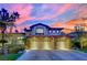 Beautiful two-story home with a three-car garage and stone accents, set against a colorful sky at 116 N Ring Dove Dr, Las Vegas, NV 89144