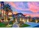 Beautiful two-story home with a lush landscaped yard highlighted by a colorful sunset backdrop at 116 N Ring Dove Dr, Las Vegas, NV 89144