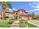 Stunning two-story home with a well-manicured front yard, stone pathway, and mature palm trees at 116 N Ring Dove Dr, Las Vegas, NV 89144