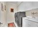 Laundry room with gray washer and dryer and white cabinets at 116 N Ring Dove Dr, Las Vegas, NV 89144