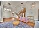 Bright living room featuring hardwood floors, a staircase, and a stylish pink couch at 116 N Ring Dove Dr, Las Vegas, NV 89144