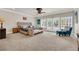 Spacious main bedroom featuring plush carpeting, sitting area, and french doors leading to the outdoors at 116 N Ring Dove Dr, Las Vegas, NV 89144