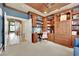 Well-lit home office with custom wood built-ins, desk, and ceiling fan at 116 N Ring Dove Dr, Las Vegas, NV 89144