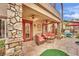 Covered outdoor patio with stone columns, seating area, and ceiling fans at 116 N Ring Dove Dr, Las Vegas, NV 89144
