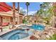 Sparkling pool and spa featuring rock waterfalls and lush landscaping, perfect for relaxation at 116 N Ring Dove Dr, Las Vegas, NV 89144