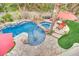 Aerial view of a stunning pool and spa with rock features and a relaxing outdoor lounge area at 116 N Ring Dove Dr, Las Vegas, NV 89144