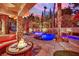 Sparkling pool and hot tub with lush landscaping and outdoor seating at twilight at 116 N Ring Dove Dr, Las Vegas, NV 89144