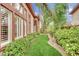 Manicured side yard with lush landscaping and large windows for natural light at 116 N Ring Dove Dr, Las Vegas, NV 89144