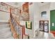 Elegant staircase with stone accents and wood railing leading to the upper level at 116 N Ring Dove Dr, Las Vegas, NV 89144
